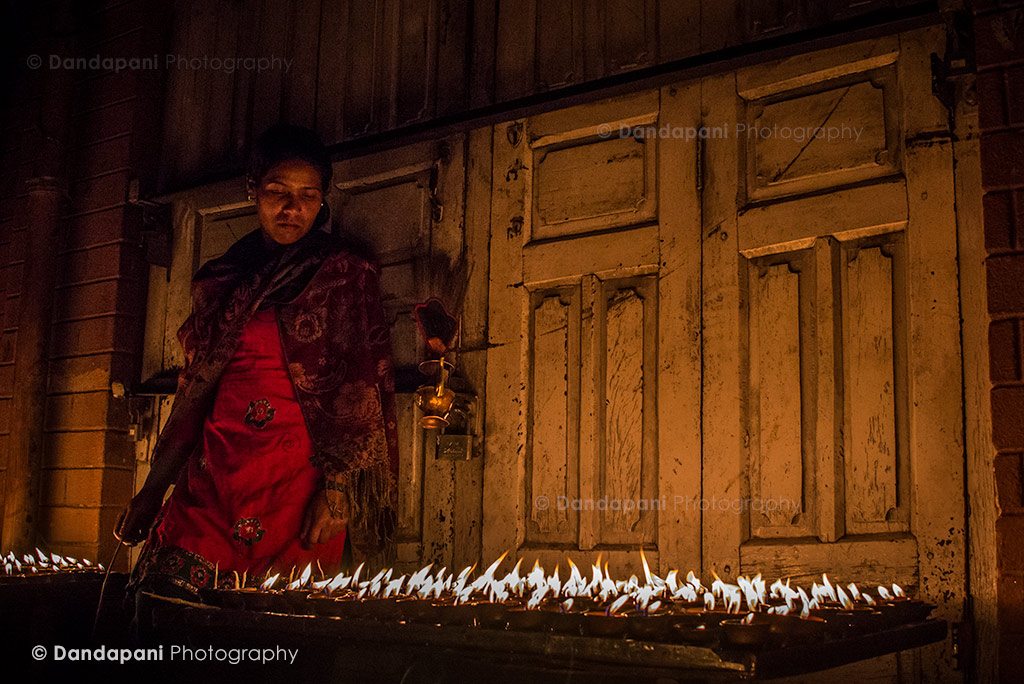 Oil lamps are sold to pilgrims who then offer it at the various shrines in and around the stupa.