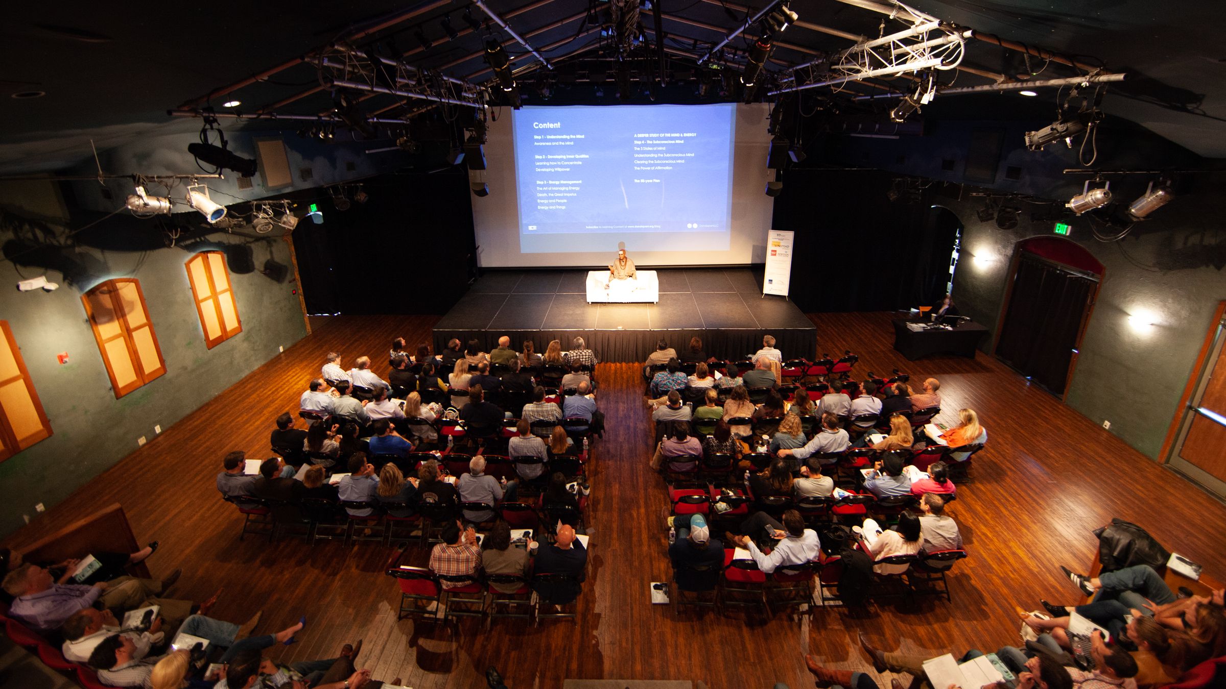 Dandapani teaching an EO audience from the stage