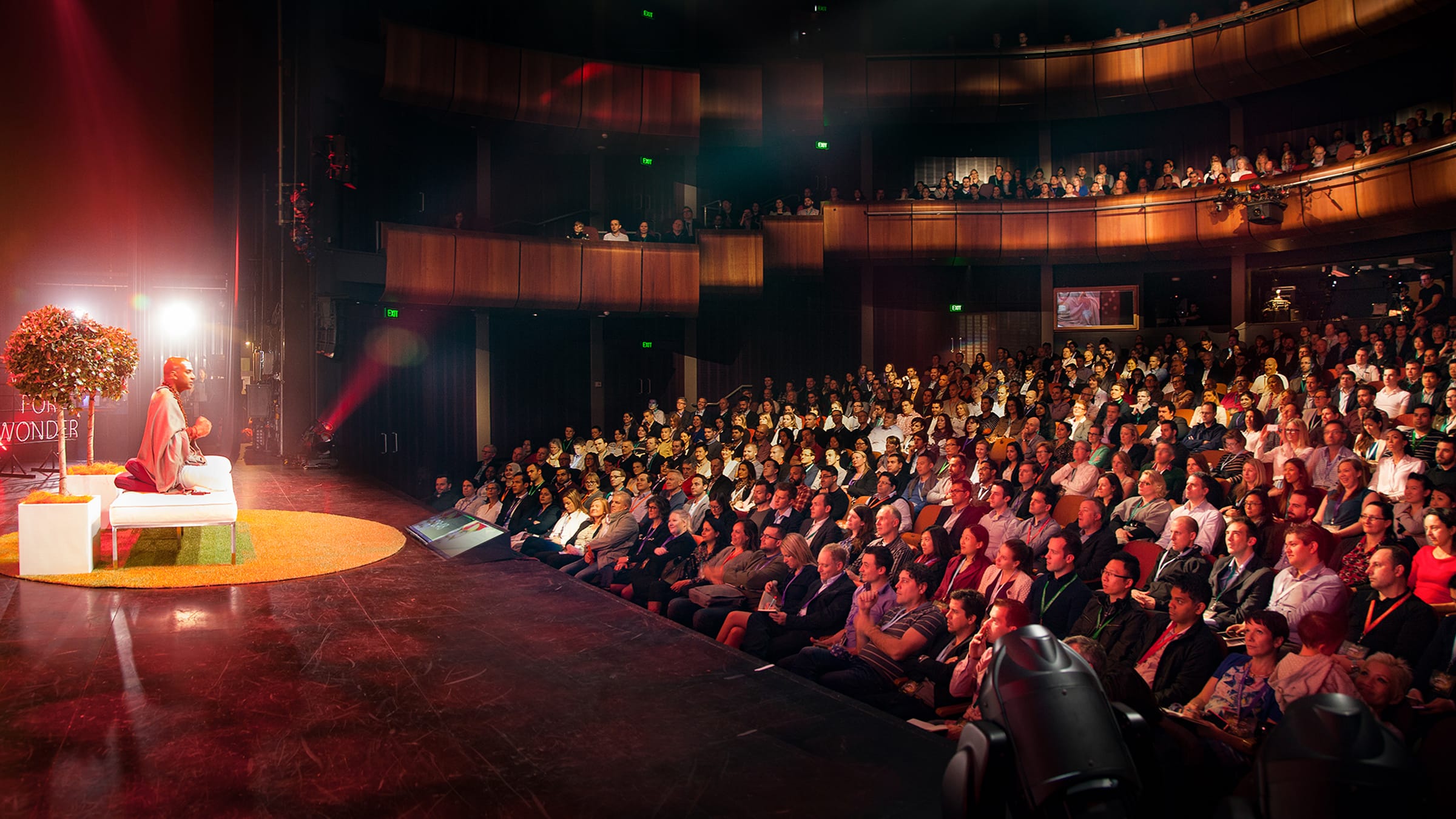 Dandapani addressing a full theater at the close of a keynote on focus and purpose