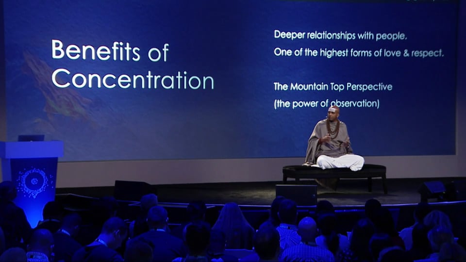 Dandapani seated on stage at Xerocon beside a slide reading “Benefits of Concentration”