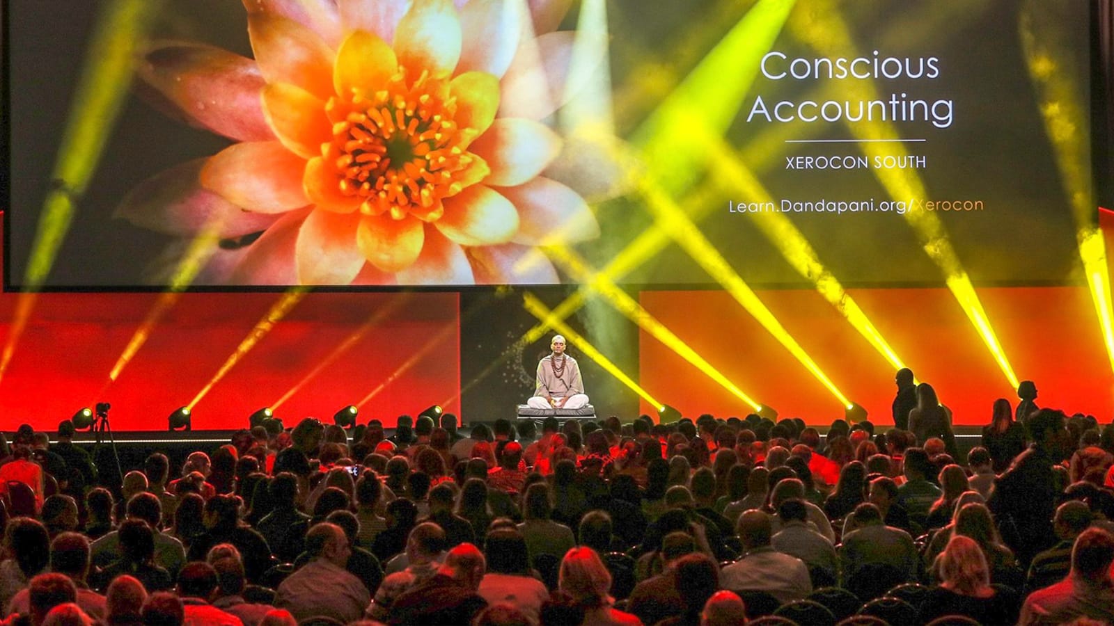 Dandapani delivering a keynote on stage in Brisbane, Australia