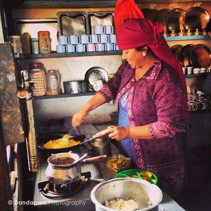 The lady at the tea house whipping up a meal.