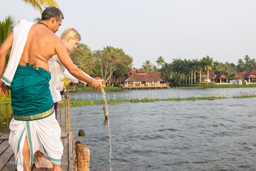 The final act of the ceremony is to offer the remnants of the water from the kumbha to the lake.