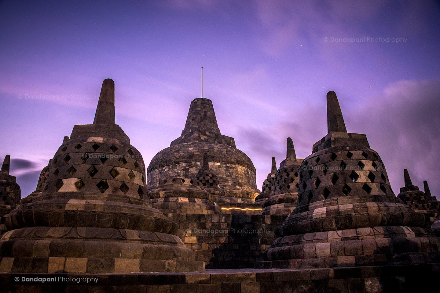 The spectacular Borobudur Temple at pre-dawn lit by a full moon. Gorgeous colors!