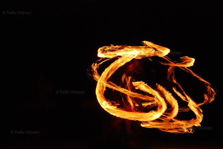 A fire dancer whirls a flaming torch in this time long exposure photo on Kauai, Hawaii.