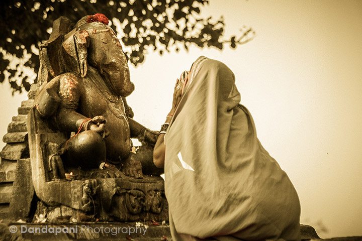 A Hindu lady worships Ganesha at the famed temples of Khajuraho in North India.