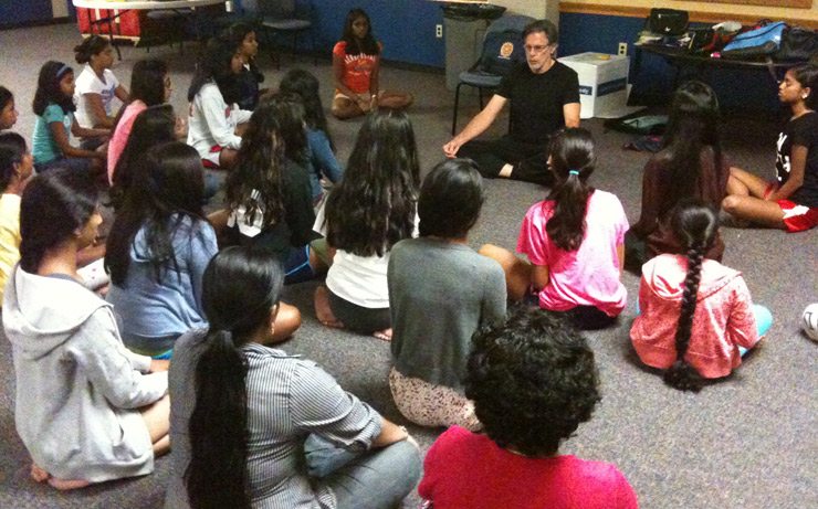 Camp starts at 7am with classes on hatha yoga and meditation. Muni teaching the girls meditation.