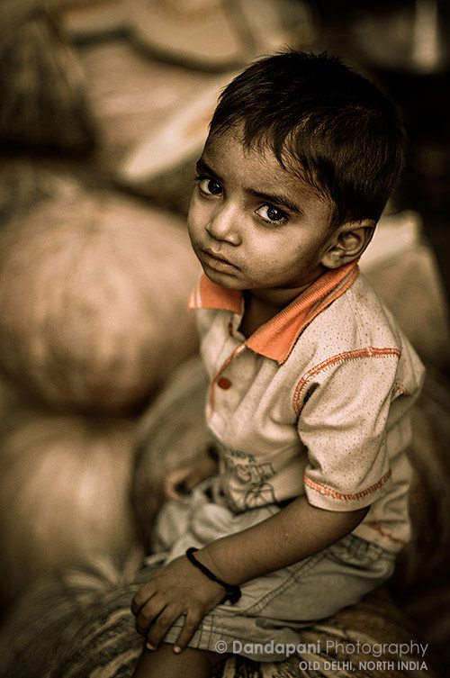 Pumpkin seller's son in Old Delhi market place, New Delhi, india