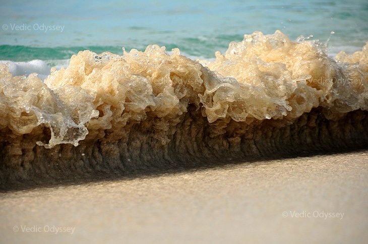 A small wave is about to make its way on to the beach on the island of Jost van Dyke in the British Virgin Islands. Caribbean.