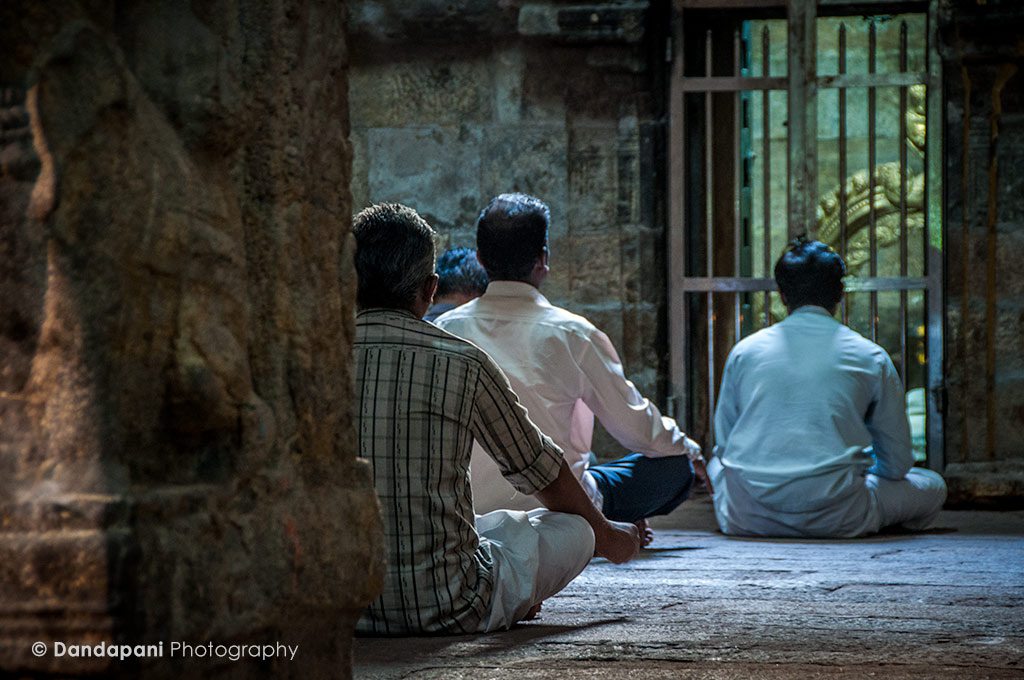 Pilgrims meditating at one of the smaller shrines surrounding the central sanctum.