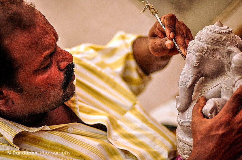 An artist does the final touches on a Ganesha statue he has carved in the small fishing village of Mamallapuram in South India.