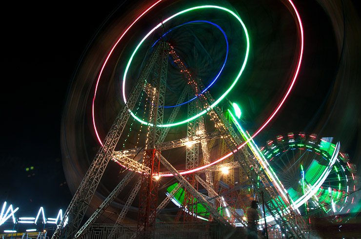 A ferris wheel in motion at night