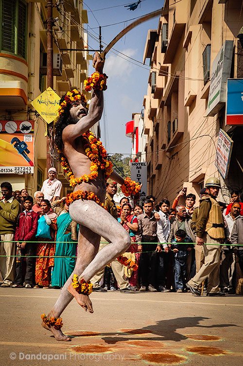 A sadhu waves his sword as he dances jubilantly during a parade at the kumbha Mela Festival